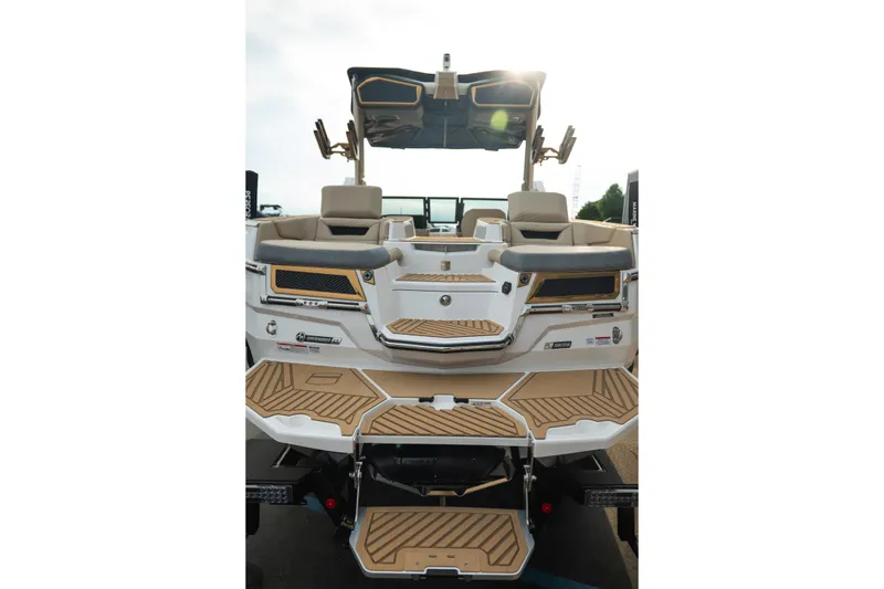 Slide: The Image of 2026 MasterCraft XStar 23 boat, rear view with luxurious seating and teak-style decking. - 9
