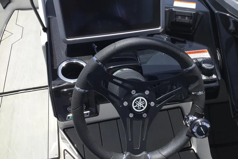 Slide: The Image of 2023 Yamaha Boats 252XE steering wheel and dashboard with modern controls and display. - 21