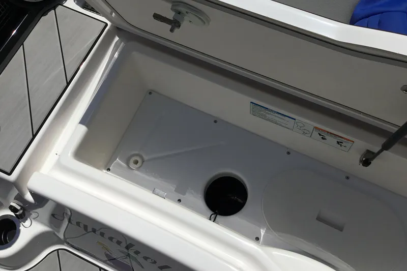 Slide: The Image of Open storage compartment on 2023 Yamaha Boats 252XE, showcasing interior space and design. - 35