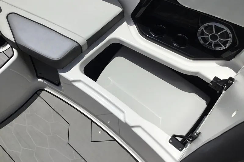 Slide: The Image of 2023 Yamaha Boats 252XE interior storage compartment with speaker and cup holders. - 17