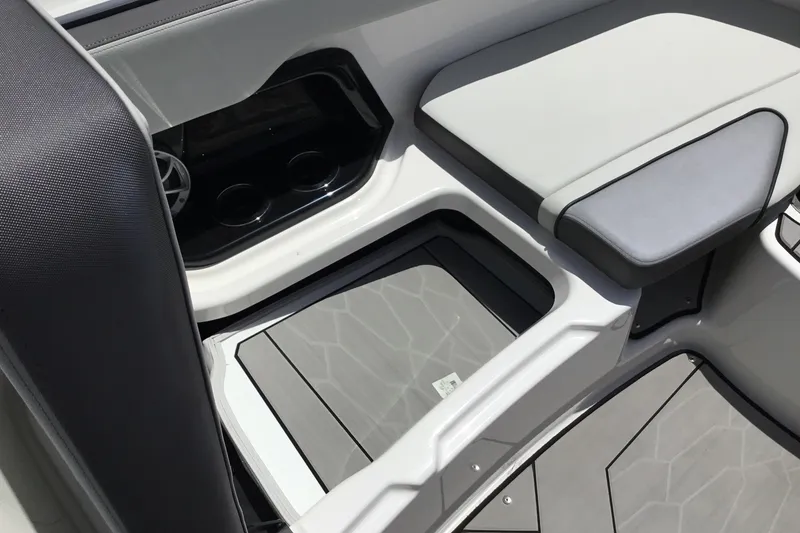 Slide: The Image of Interior seating and storage of 2023 Yamaha Boats 252XE, featuring sleek design and cup holders. - 16