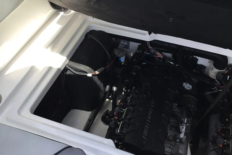 Slide: The Image of Engine compartment of 2023 Yamaha Boats 252XE, showcasing internal components and wiring. - 31