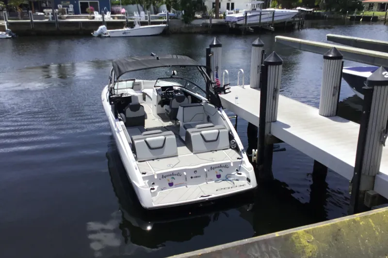 Slide: The Image of 2023 Yamaha Boats 252XE docked at a marina, showcasing sleek design and modern features. - 39