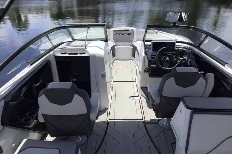 Slide: The Image of 2023 Yamaha Boats 252XE interior with modern seating and sleek dashboard design. - 33