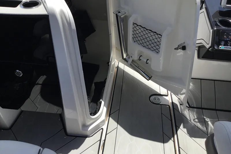 Slide: The Image of Interior view of 2023 Yamaha Boats 252XE, featuring open storage compartment and sleek flooring. - 27