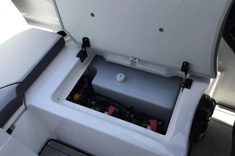 Slide: The Image of Open storage compartment in 2023 Yamaha Boats 252XE, showcasing interior components. - 22