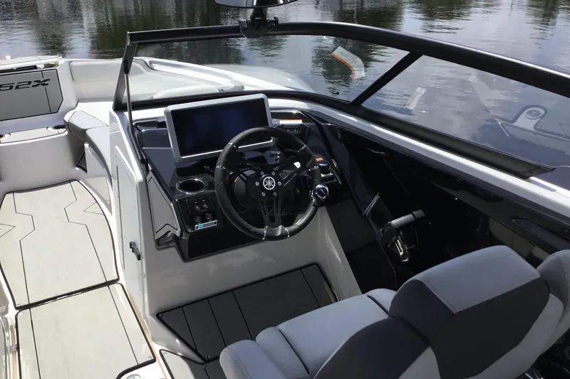 Slide: The Image of 2023 Yamaha Boats 252XE cockpit with modern steering and dashboard controls. - 20