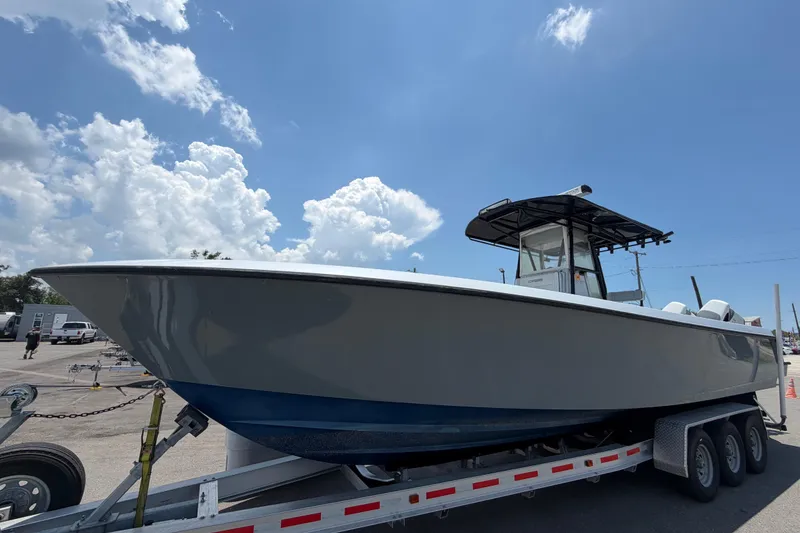 The Image of 2007 Contender 33 Tournament boat on trailer under a bright blue sky. - 0