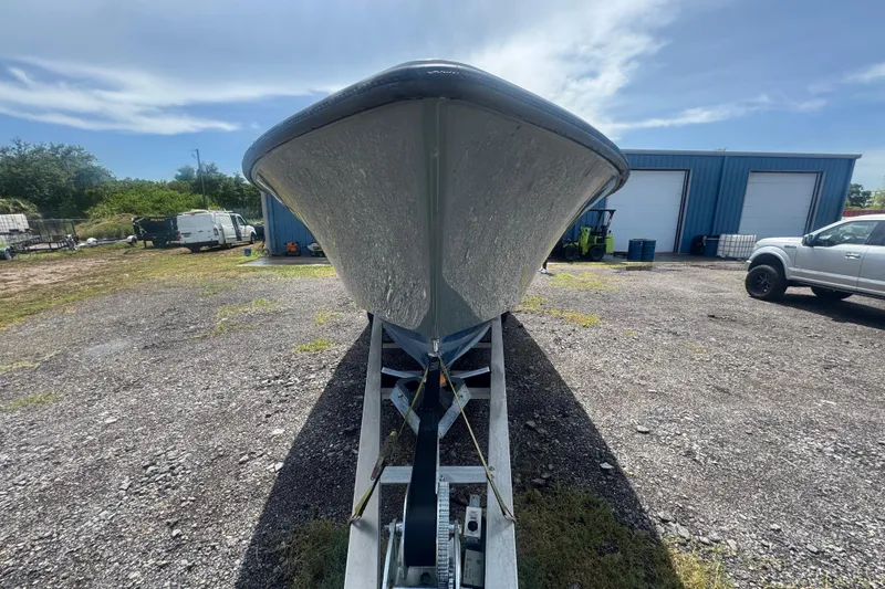 Slide: The Image of 2007 Contender 33 Tournament boat on trailer, parked near blue warehouse. - 10