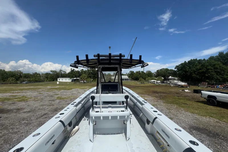 Slide: The Image of 2007 Contender 33 Tournament boat on land, clear sky, surrounded by trees and vehicles. - 12