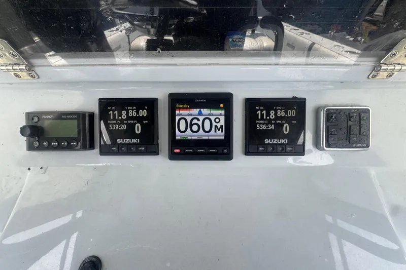 Slide: The Image of Dashboard of a Contender 33 Tournament boat with various electronic displays. - 14