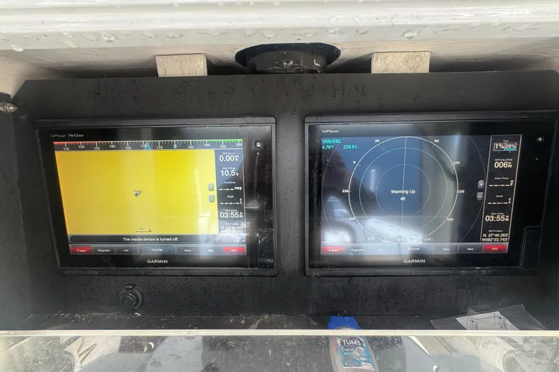 Slide: The Image of Garmin navigation screens on a 2007 Contender 33 Tournament boat dashboard. - 15