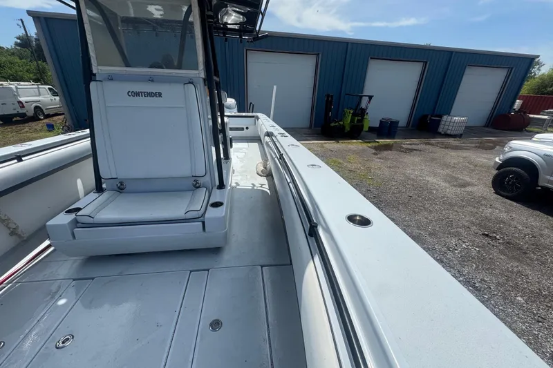 Slide: The Image of 2007 Contender 33 Tournament boat docked near blue storage units. - 17