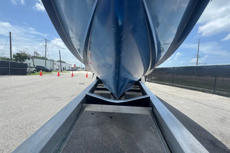 Slide: The Image of 2007 Contender 33 Tournament boat on trailer, viewed from below, outdoors on a sunny day. - 18