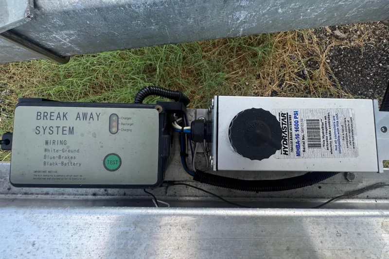 Slide: The Image of Close-up of a trailer system with a break-away system and hydraulic system. - 22