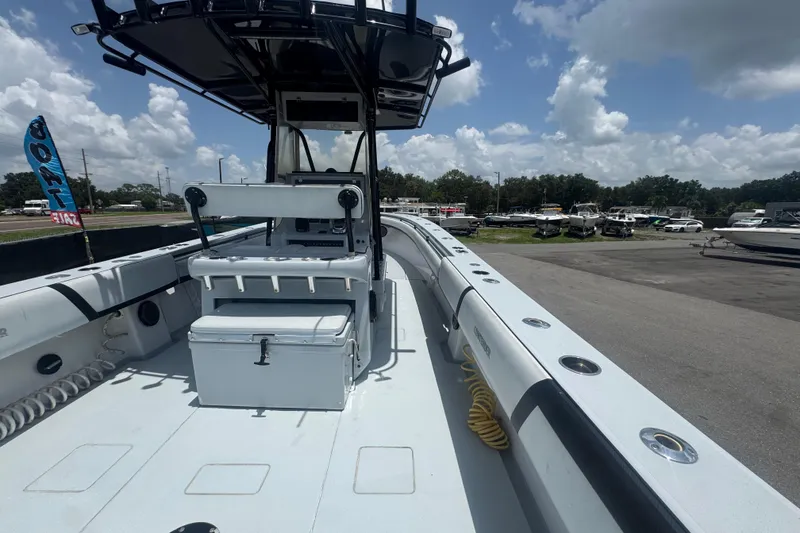 Slide: The Image of 2007 Contender 33 Tournament boat with center console, docked under a partly cloudy sky. - 21