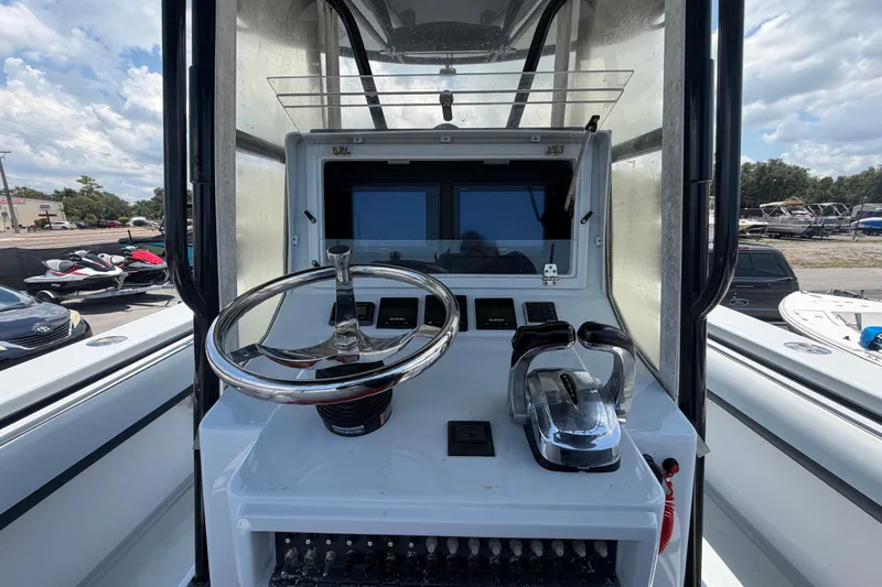 Slide: The Image of 2007 Contender 33 Tournament boat helm with steering wheel and dual controls. - 14