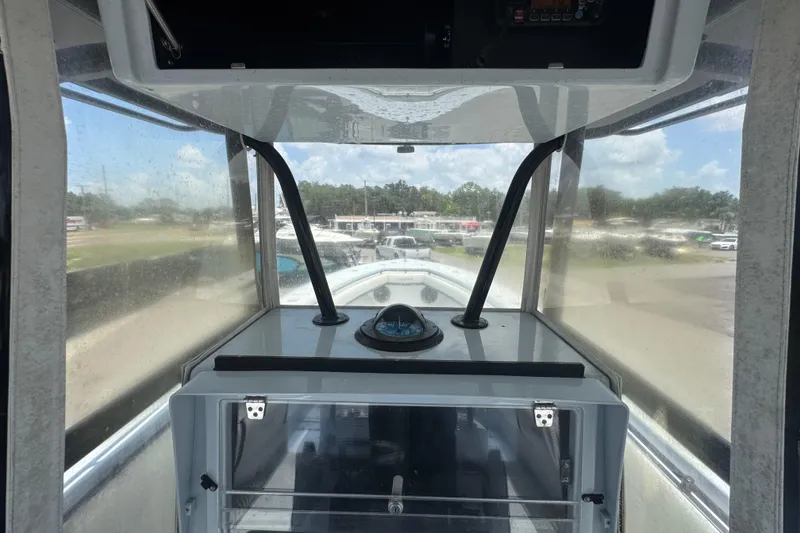 Slide: The Image of Interior view of a 2007 Contender 33 Tournament boat cockpit with compass and clear windows. - 30