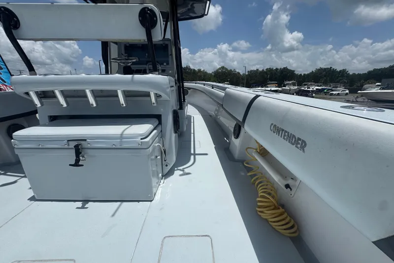 Slide: The Image of 2007 Contender 33 Tournament boat deck with seating and storage, under a partly cloudy sky. - 24