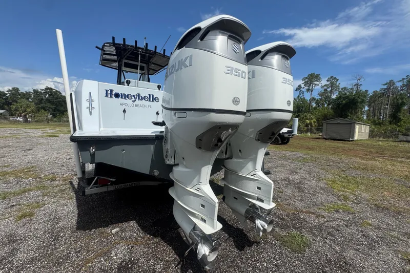 Slide: The Image of 2007 Contender 33 Tournament boat with twin Suzuki 350 engines, parked outdoors. - 3