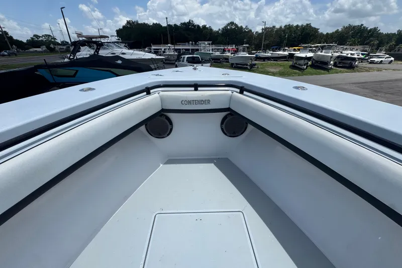 Slide: The Image of 2007 Contender 33 Tournament boat interior with seating and speakers, docked among other boats. - 43