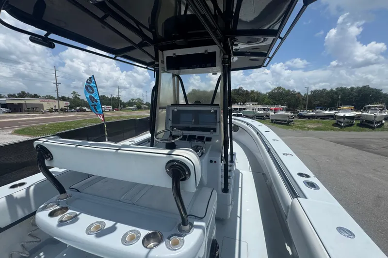 Slide: The Image of 2007 Contender 33 Tournament boat interior with steering console and seating, parked outdoors. - 26