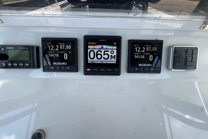 Slide: The Image of Dashboard of a 2007 Contender 33 Tournament boat with Suzuki and Garmin displays. - 34