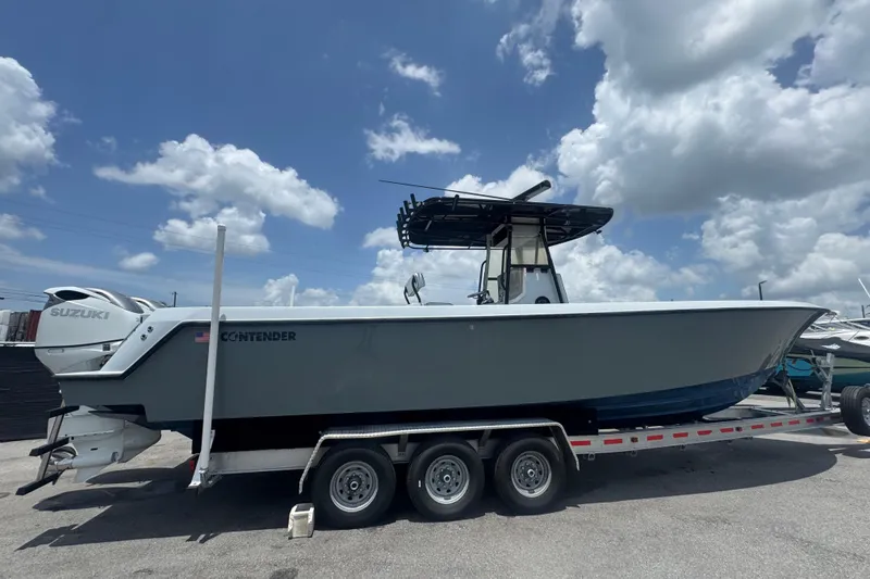 Slide: The Image of 2007 Contender 33 Tournament boat on trailer under a cloudy sky. - 3