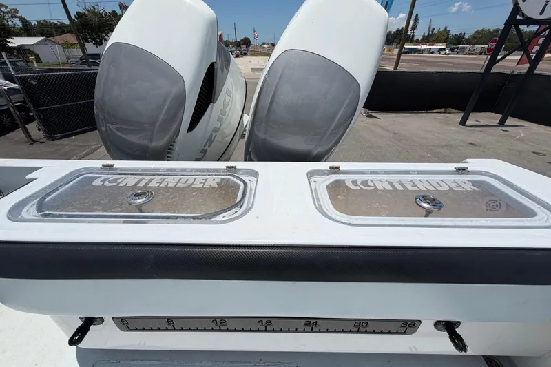 Slide: The Image of 2007 Contender 33 Tournament boat with dual Suzuki engines, featuring branded storage compartments. - 29
