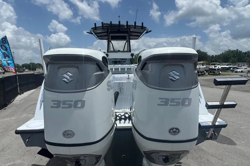 Slide: The Image of Two Suzuki 350 outboard engines on a Contender 33 Tournament boat, with a blue sky background. - 6