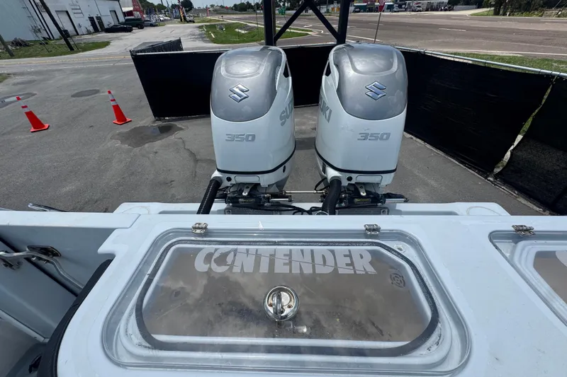 Slide: The Image of 2007 Contender 33 Tournament boat with dual Suzuki 350 engines, parked outdoors. - 69