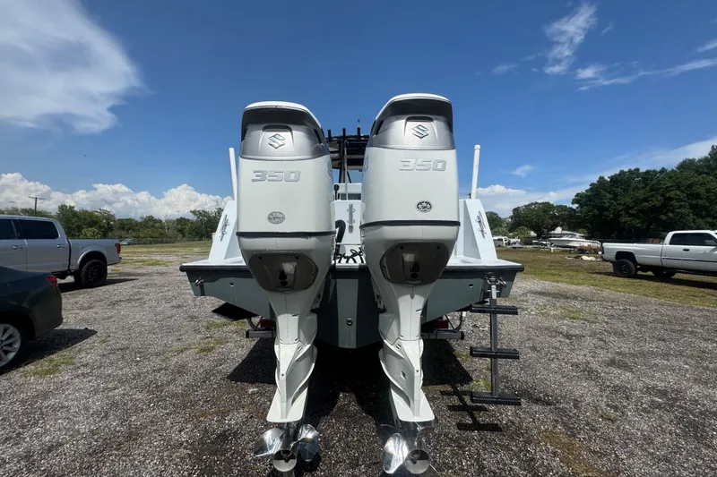 Slide: The Image of 2007 Contender 33 Tournament boat with twin Suzuki 350 outboard engines, parked outdoors. - 5