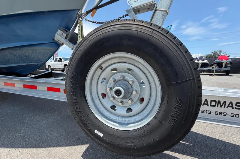 Slide: The Image of Trailer wheel of a 2007 Contender 33 Tournament boat on asphalt. - 36