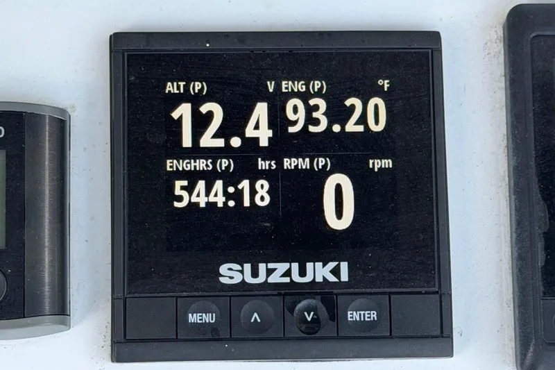 Slide: The Image of Suzuki engine display showing 12.4 volts, 93.20°F, 544:18 hours on a 2007 Contender 33 Tournament. - 16