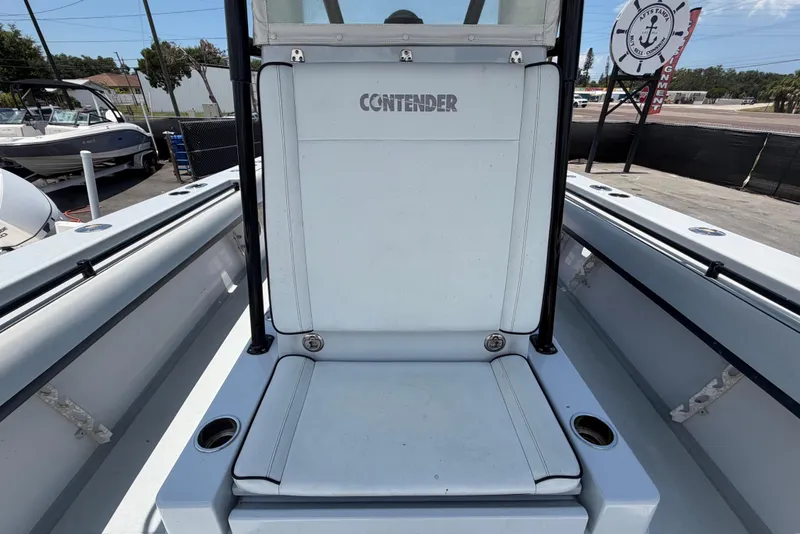 Slide: The Image of The image shows the cockpit of a 2007 Contender 33 Tournament boat with a central seating area. - 24