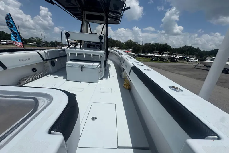Slide: The Image of 2007 Contender 33 Tournament boat deck with seating and storage, under a clear blue sky. - 22
