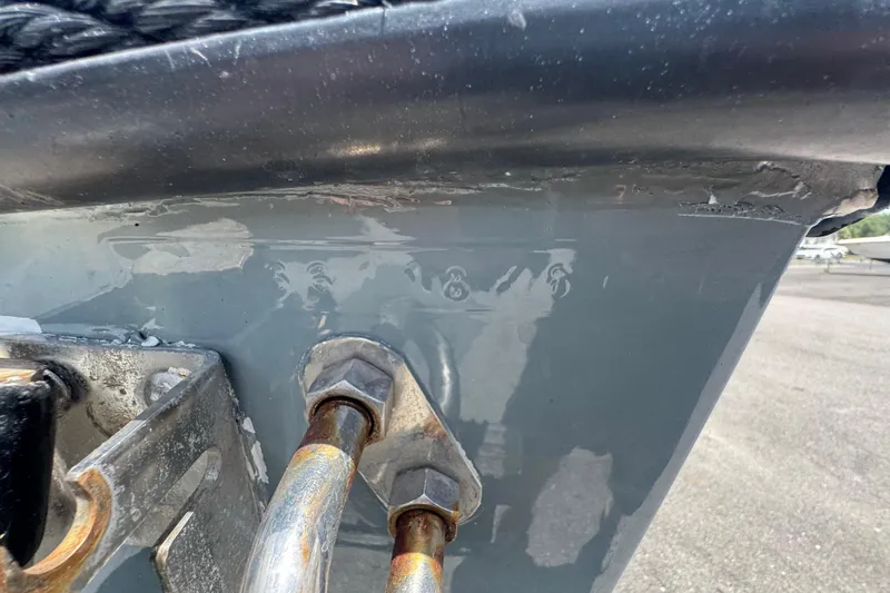 Slide: The Image of Close-up of a 2007 Contender 33 Tournament boat's hull with visible wear and bolts. - 83