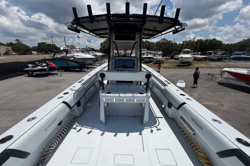 Slide: The Image of 2007 Contender 33 Tournament boat with center console, docked among other vessels under a cloudy sky. - 12
