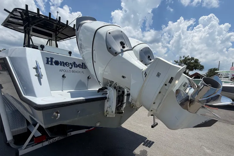 Slide: The Image of The image shows the stern of a 2007 Contender 33 Tournament boat with two large outboard engines. - 3