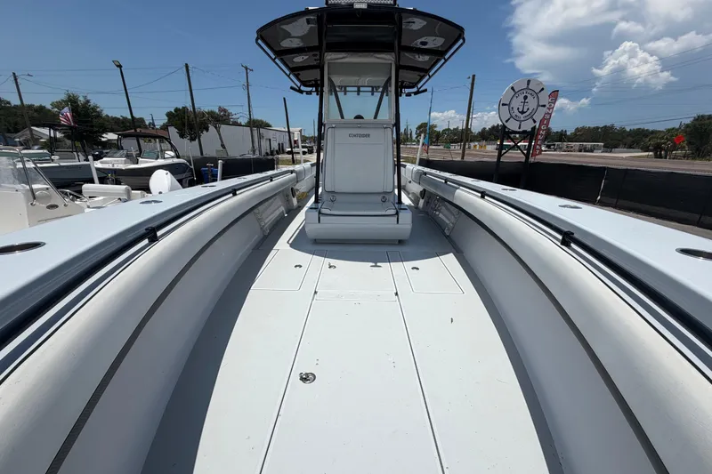 Slide: The Image of 2007 Contender 33 Tournament boat, spacious deck, clear sky, marina background. - 21