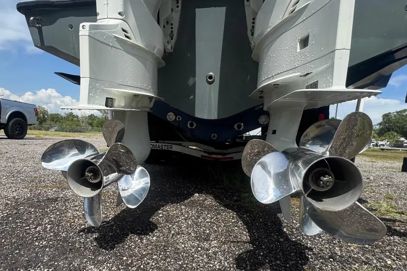 Slide: The Image of Two shiny propellers on a boat in a gravel lot. - 6