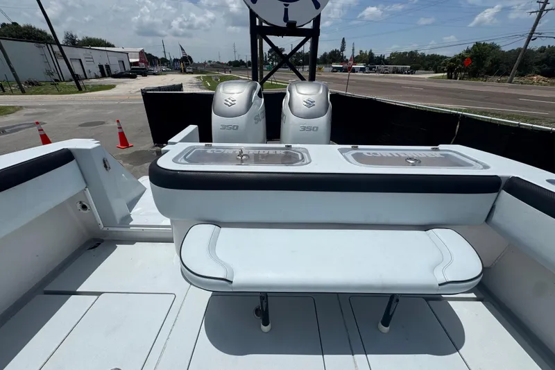 Slide: The Image of 2007 Contender 33 Tournament boat with dual Suzuki 350 engines, docked outdoors. - 65