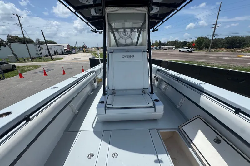 Slide: The Image of 2007 Contender 33 Tournament boat interior with seating and storage, parked on a sunny day. - 49
