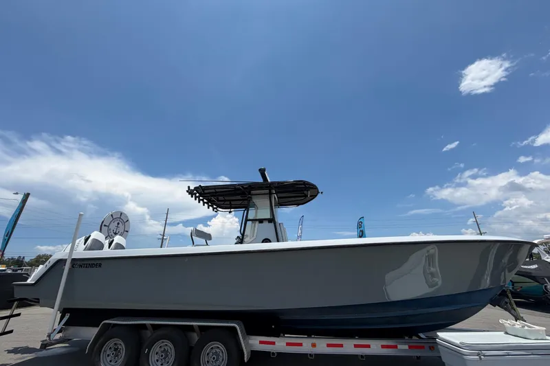 Slide: The Image of 2007 Contender 33 Tournament boat on trailer under clear blue sky. - 8