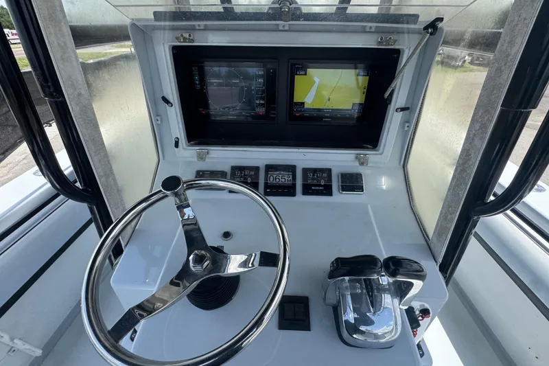 Slide: The Image of Helm of 2007 Contender 33 Tournament boat with steering wheel and navigation screens. - 32