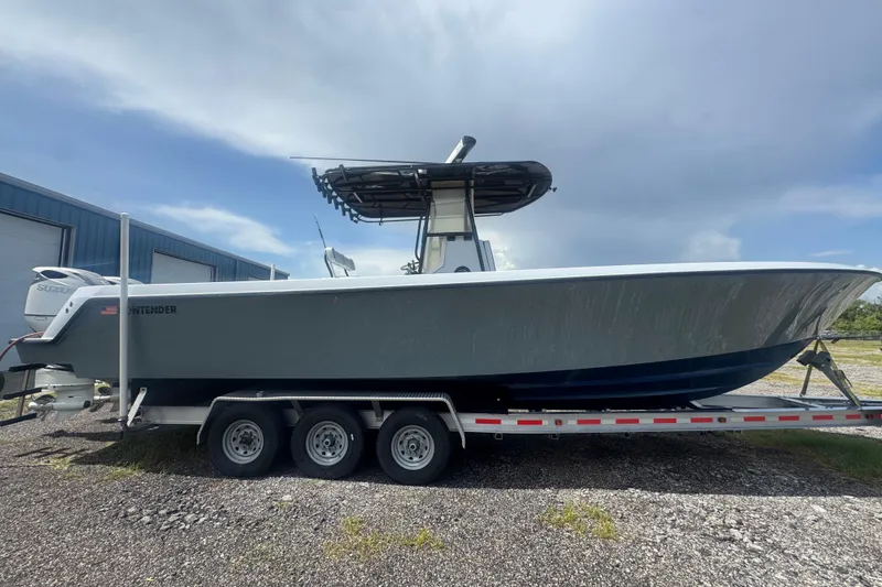 Slide: The Image of 2007 Contender 33 Tournament boat on trailer, side view, outdoors. - 7