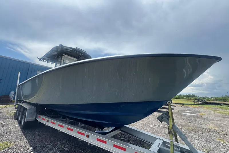 Slide: The Image of 2007 Contender 33 Tournament boat on trailer under cloudy sky. - 8