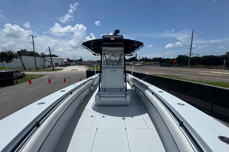 Slide: The Image of 2007 Contender 33 Tournament boat, spacious deck, clear sky, parked on roadside. - 44