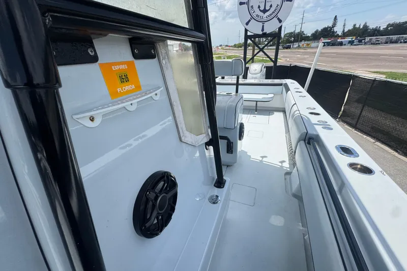 Slide: The Image of 2007 Contender 33 Tournament boat interior with Florida registration sticker, docked outdoors. - 57