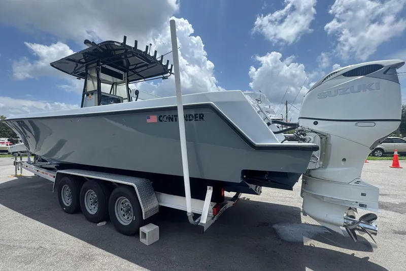 Slide: The Image of A gray 2007 Contender 33 Tournament boat on a triple-axle trailer. - 12